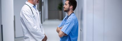 doctor-and-male-nurse-interacting-with-each-other-2021-08-28-17-20-25-utc-Custom.jpg